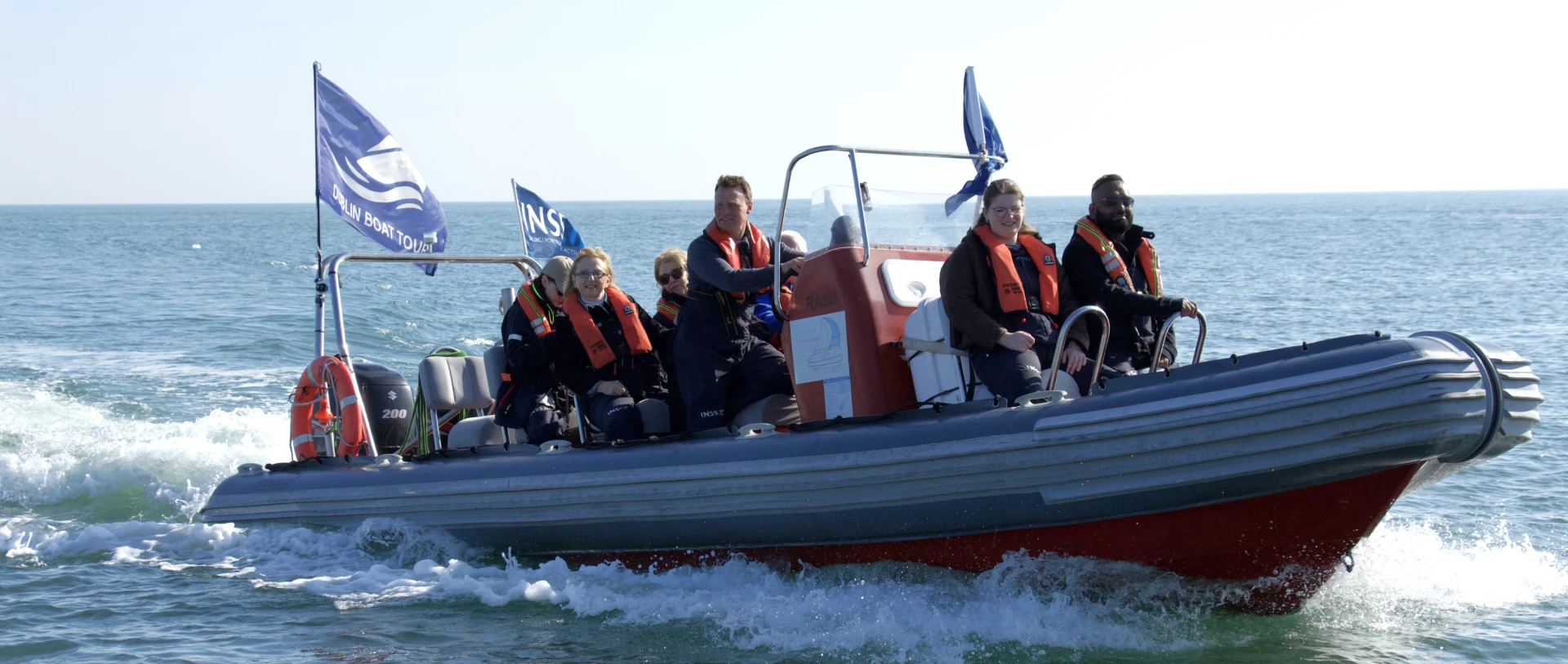 Scenic boat tour across Dublin Bay with passengers enjoying coastal views and open waters
