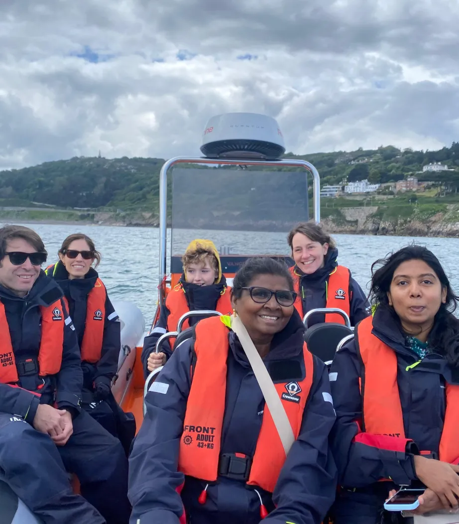 School group of children and teachers enjoying an educational boat tour experience on the river